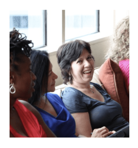 A group of woman from Love U sitting on a couch while listening.