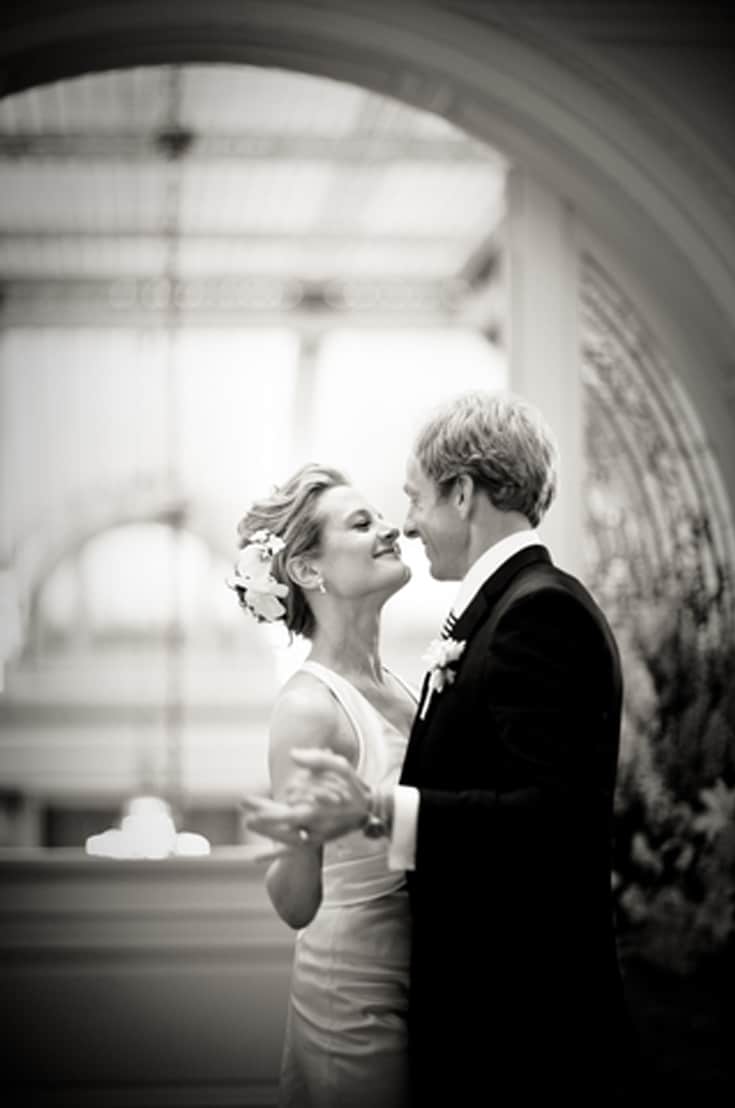 happy newly married couple gazing at each other while dancing