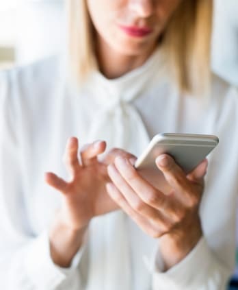 a lady typing on her smartphone