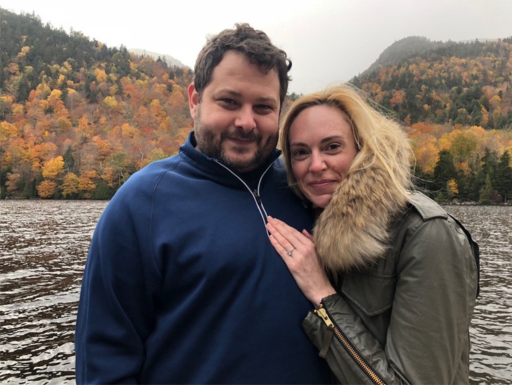 engaged couple on a lake