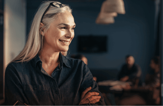 confident smart strong successful woman with long white hair smiling and crossing her arms