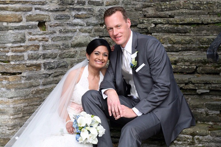 a couple in their wedding attires posing for a shot