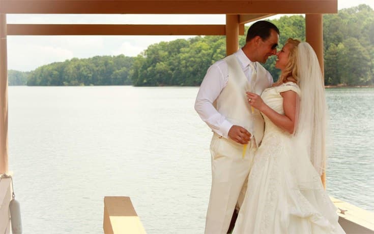 happy newly married couple at the lake house