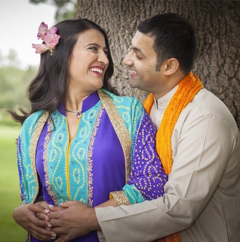 Love U love story of successful woman with a flower on her right ear smiling to husband